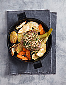 A beef steak with an amaranth crust and roasted vegetables