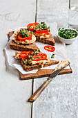 Open hummus sandwiches with pointed peppers and garden cress