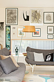 Scandinavian style sofas in front of a picture wall with a horizontal window