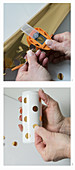 Hand-crafting vases: punching dots out of metallic adhesive foil and sticking on drinks can