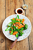Mange tout salad with carrots and pine nuts
