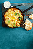 Indian style fish pie with a cauliflower and potato crust