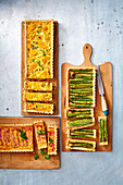 Three quiches: corn and chicken, asparagus, and bacon