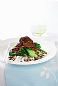 Marinated beef with onion and pak choi on rice