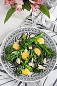 Broccolini with dressing and almond flakes