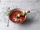 Cold Mediterranean tomato soup with a mozzarella and olive skewer