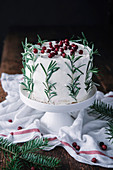 Christmas mascarpone cake decorated with rosemary and cranberries