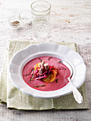 Cream of red cabbage with goose meat and potato dumplings