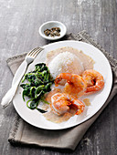 Fried scampi with cinnamon star sauce, spinach and rice