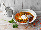 Red lentil soup with savoy cabbage and sour cream