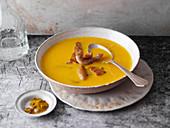 Pumpkin and carrot soup with fried turkey strips