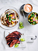 Flank steak tacos with corn, avocado and coriander