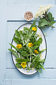 A wild herb salad with pansies on an elderflower dressing