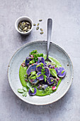 Purple potato salad on green sauce
