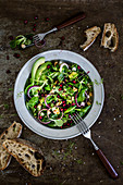 Mixed leaf salad with avocado and pomegranate seeds
