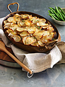 Beef and bacon casserole with crispy potato topping