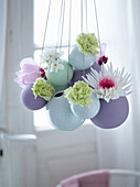 Easter arrangement of flowers in suspended spherical vases