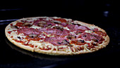 Salami pizza in an oven