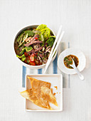 Romaine lettuce with marinated beef slices and fried Wantan leaves