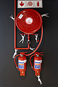 Fire extinguishers on black wall