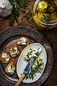 Marinated labne balls with herbs served on toast