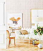 White cushion sofa on parquet floor against wallpapered wall