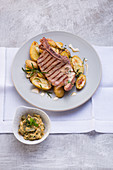 A veal cutlet with potatoes and spiced butter sauce