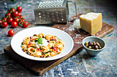 Fresh orecchiette pasta in a rich sauce with cherry tomatoes, green and kalamata olives, capers, fresh basil and ricotta cheese