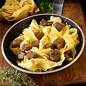 Beef and noodles in skillet
