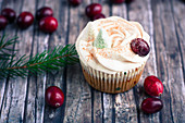 A winter apple and cranberry cupcake with cider and frosting