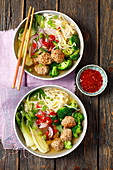 Rice noodle soup with meatballs, bok choy, broccoli and chilli (Asia)