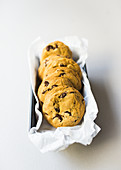 Chocolate chip cookies with paper in a tin