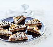 Baked sesame and coconut slices with redcurrant jam and chocolate icing (vegan)