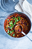 Chili con carne with beans and chickpeas in a saucepan