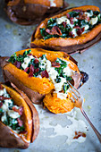 Sweet potatoes stuffed with kale, bacon and cheese