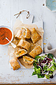 Pork and pumpkin sausage rolls with spiced tomato sauce