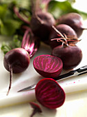 Beetroot with a kitchen knife on a chopping board