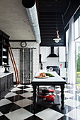 Renovated kitchen in black and white with glossy ceramic floor tiles