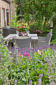 Outdoor furniture on terrace of converted stable