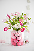 Easter bouquet in glass vase full of Easter eggs