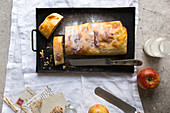 Apple strudel dusted with icing sugar, cut open