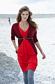 Langhaarige Frau in rotem Kleid und Strickjacke