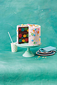 Devils Food Cake with polka dots on a cake stand, sliced