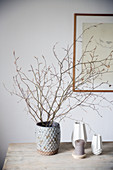 Twigs in a vase on a wooden table