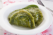 Spinach pierogi (cooked dumplings) with cottage cheese