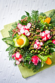 Bouquet of lettuce, cucumber, cherry tomatoes and radishes on a green napkin