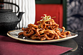 Filipino style deep fried crispy squid glazed with chilli honey and garlic