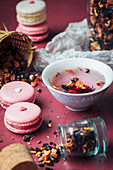Berry macarons wih hearts and red tea