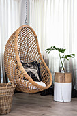 Hanging chair and tree-stump table in corner