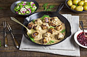 Swedish meatballs in a creamy sauce with cucumber salad and new potatoes